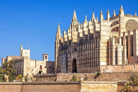 View at the Palma Cathedral of Santa Maria of Palma with tourist outside on the terrace a sunny