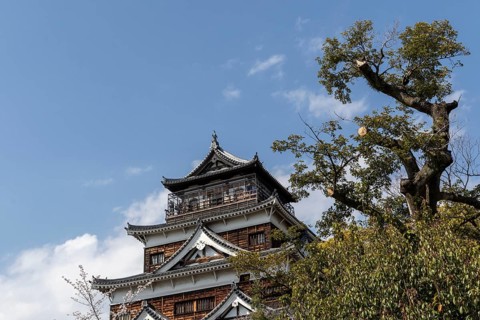 Hiroshima Castle, also known as Carp Castle, against a blue sky, replica of the original destroyed