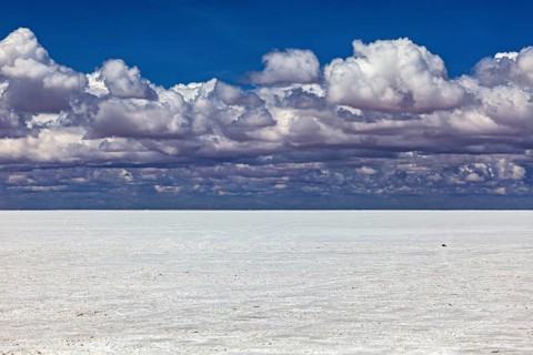 Cloudy sky over a flat salt landscape with a calm atmosphere, The endless expanses of the salt