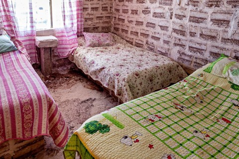 Rustic bedroom with patterned beds and pink and green-coloured textiles, The salt hotel in the salt
