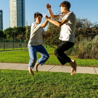 Two young men performing aerial Taekwondo kicks
