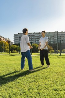 Young martial artists greeting each other before a training session