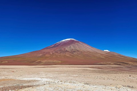 Majestic volcano in the middle of a dry, barren desert landscape, The landscape of the Altiplano in
