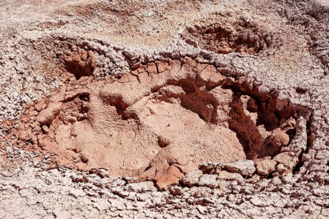 Large geothermal crater with dried mud and cracks, The mud volcanoes and fumaroles on the Altiplano