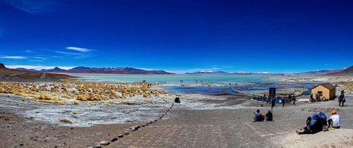 Panorama with sweeping views over a lake and mountains in an arid desert landscape, The Aguas