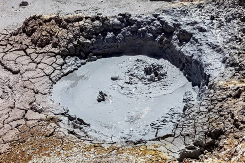 Small mud pool in eroded geothermal crater, The mud volcanoes and fumaroles on the Altiplano in