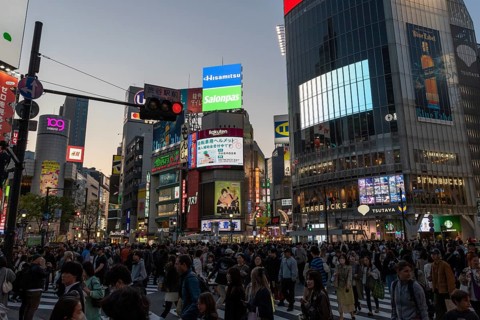 Crowd crossing the zebra crossings of Shibuya Crossing, world-famous intersection in Shibuya