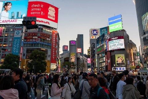 Crowd crossing the zebra crossings of Shibuya Crossing, world-famous intersection in Shibuya