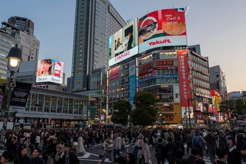 Crowd crossing the zebra crossings of Shibuya Crossing, world-famous intersection in Shibuya