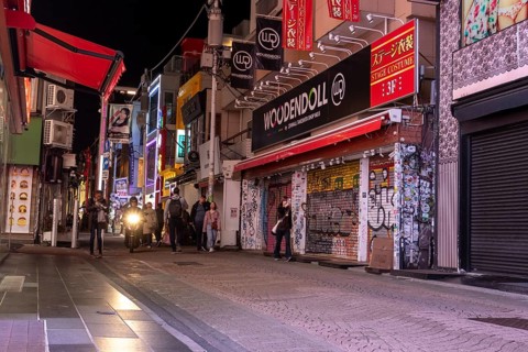 Tourists walk through the narrow alley of Takeshita-dori, Takeshita Street, with souvenir shops and