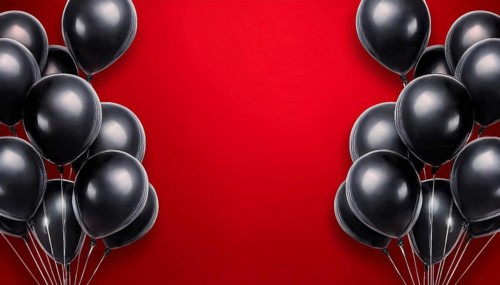 A striking arrangement of black balloons on a vibrant red background with open space in the center,