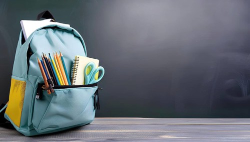 A blue backpack with a yellow pocket sits on a wooden table. Inside the backpack, there are