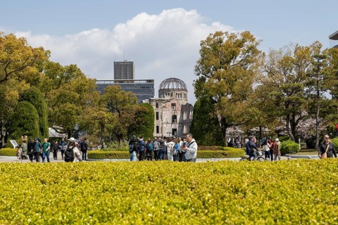 Tourists in the Peace Park with a view of the ruins of the Atomic Bomb Dome, landmark, UNESCO World