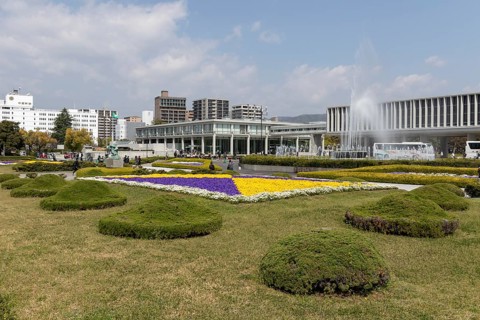 Colourful flower beds and fountains in front of the Hiroshima Peace Museum, tourist attraction,