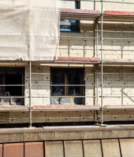 Scaffolding on a building being insulated with thermal insulation panels, Wuppertal, Germany