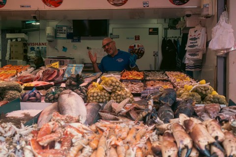 Market vendor with fresh catch at the weekly market market. De Haagse Markt, The Hague, Netherlands