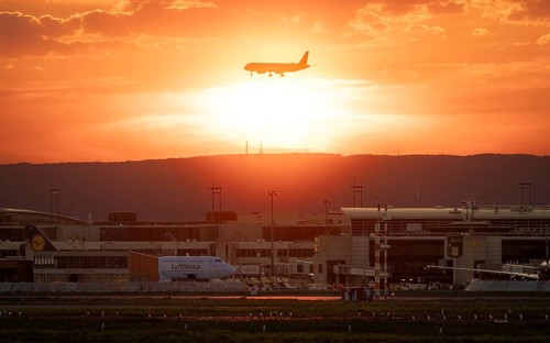 Plane on final approach at sunset. Frankfurt am Main Airport, Hesse, Germany