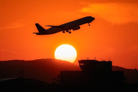 Aircraft takes off in the sunset. Frankfurt Airport, Hesse, Germany