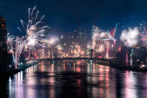New Year's Eve fireworks illuminate the night skyline on the Main. Frankfurt city centre, Hesse,