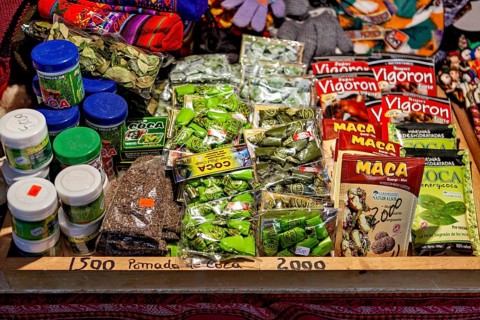 Market stall with a selection of coca products and traditional medicinal items in colourful