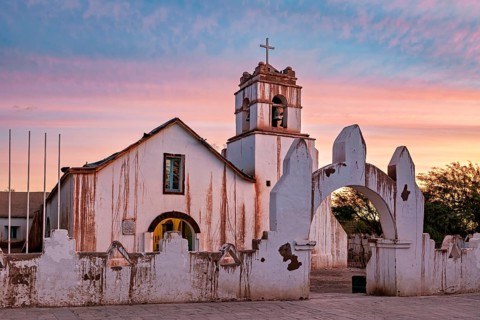 Church at sunset, warm colour palette with illuminated sky and cross tower, The church of San Pedro