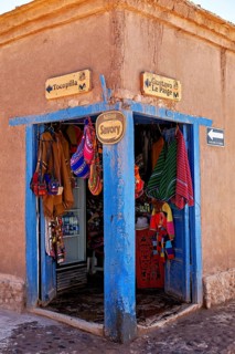Corner of a souvenir shop with colourful textiles and handicrafts. Rustic style with striking blue