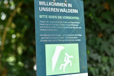 Mannheim, Germany - August 31st 2025: Warning sign at entrance of Dossenwald forest about danger of