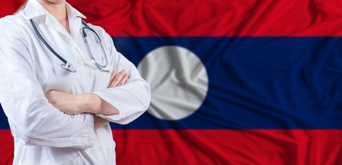 Doctor with crossed arms on Laos flag. Laotian health and care concept. Female doctor on Laos flag