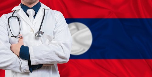 Male doctor with stethoscope on Laotian flag. Doctor holding stethoscope on Laos flag