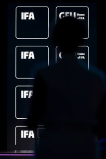 Logos of IFA and GFU behind the silhouette of a person at the opening gala of the IFA