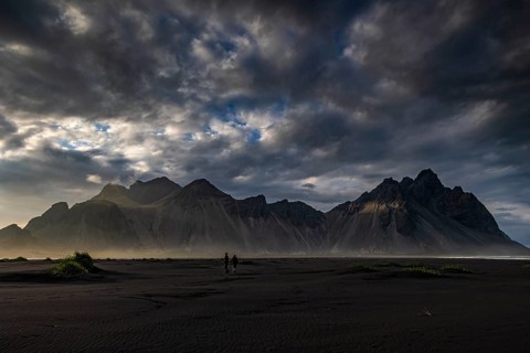 Two people standing on the beach, couple, adult, mountains, mountain range, sea, cloudy mood,