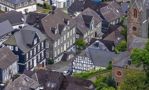Aerial view, Protestant town church and green trees on Schlossstraße, residential area with