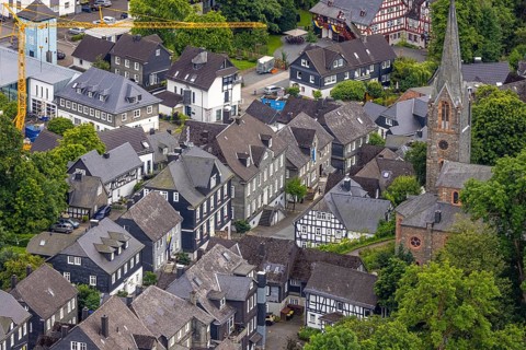 Aerial view, Protestant town church and green trees on Schlossstraße, residential area with
