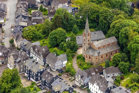 Aerial view, protestant town church and green trees on Schlossstraße, residential area with