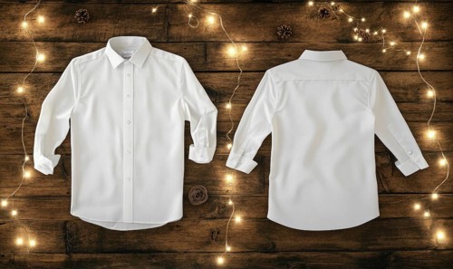 Two white shirts are displayed on a wooden surface. The shirts are hanging on a wall and are not