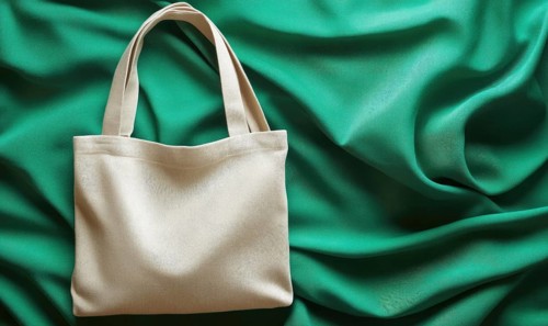 A white purse is on a green background. The purse is empty and the background is a bright green