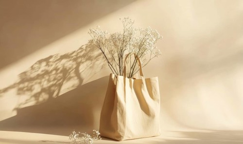 A fabric bag filled with white flowers, casting shadows on a beige backdrop. AI generated