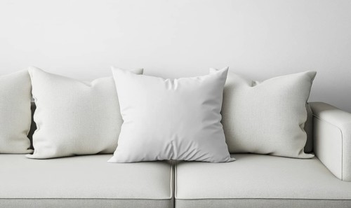 A minimalist white sofa adorned with soft pillows creates a serene and modern setting. AI generated