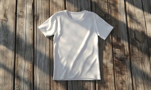 A white shirt is laying on a wooden surface. The shirt is unbuttoned and has a collar. The shirt is
