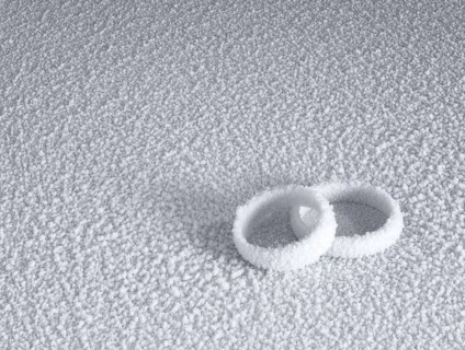 Studio photography of two frosted wedding rings in cold ambiance