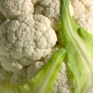 Full frame detail of a cauliflower and leaves