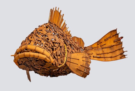 Rusty fish sculpture isolated in light back