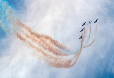 Air show of the Frecce Tricolori aerobatic team of the Italian Air Force with colored smoke trails