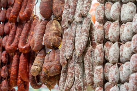 Closeup shot showing various air-dried salame sausages seen in Italy