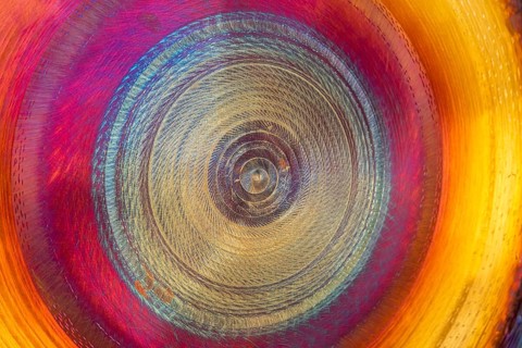Full frame abstract detail shot of a colorful metallic gong