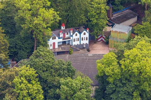 Aerial view, open-air stage covered by trees and neighbouring buildings with towers, Herdringen,