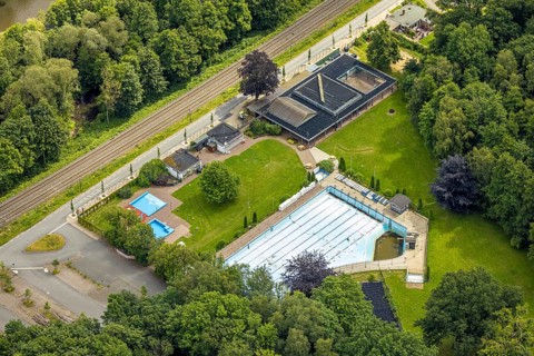 Aerial view, outdoor swimming pool Neheim, swimming pool without water, in the forest area at the