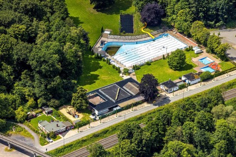 Aerial view, outdoor swimming pool Neheim, swimming pool without water, in the forest area at the