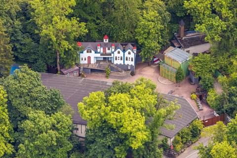 Aerial view, open-air stage covered by trees and neighbouring buildings with towers, Herdringen,