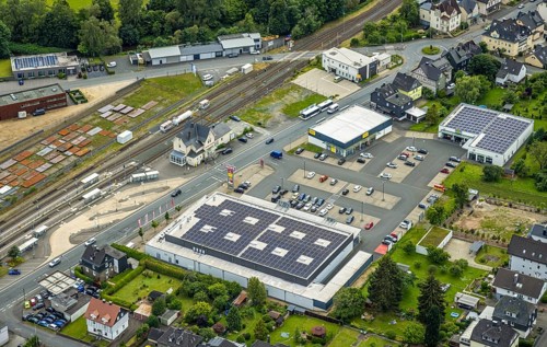 Aerial view, Bahnhofstrasse shopping centre with Rewe supermarket and solar roof, Takko fashion and
